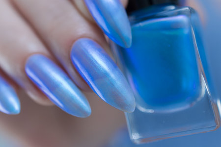 Woman's beautiful hand with long nails and light baby blue manicureの写真素材