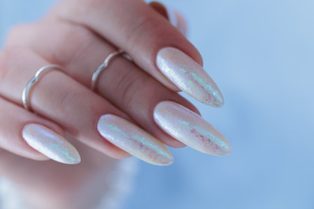 beautiful female hands with long nails light white manicureの写真素材