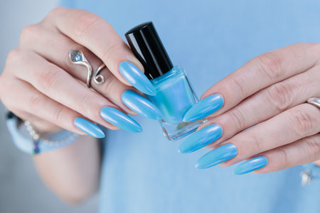 Woman's hand with long nails and baby blue manicureの写真素材