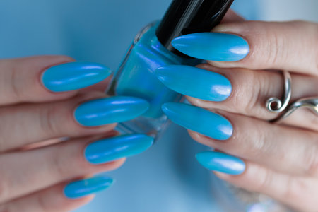 beautiful hand with long nails and light baby blue manicureの写真素材
