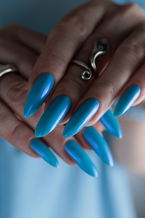 beautiful hand with long nails and light blue manicureの写真素材