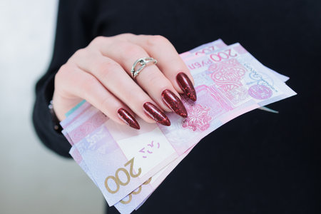Female hands holding paper bills Belarusian rublesの写真素材