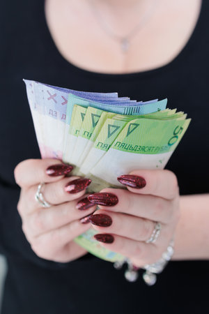 Female hands holding paper bills Belarusian rublesの写真素材