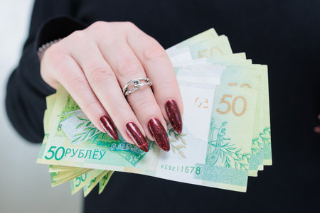 Female hands holding paper bills Belarusian rublesの写真素材