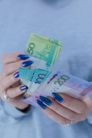 Female hands holding paper bills Belarusian rublesの写真素材