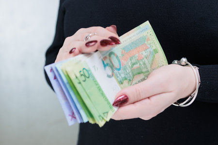 Female hands holding paper bills Belarusian rublesの写真素材