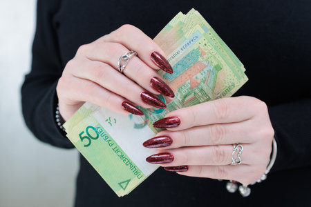 Female hands holding paper bills Belarusian rublesの写真素材