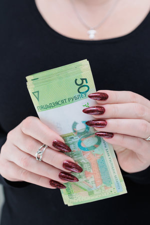 Female hands holding paper bills Belarusian rublesの写真素材