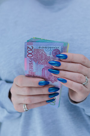 Female hands holding paper bills Belarusian rublesの写真素材