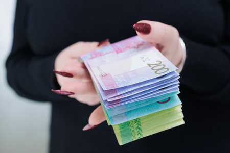 Female hands holding paper bills Belarusian rublesの写真素材