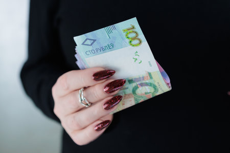 Female hands holding paper bills Belarusian rublesの写真素材