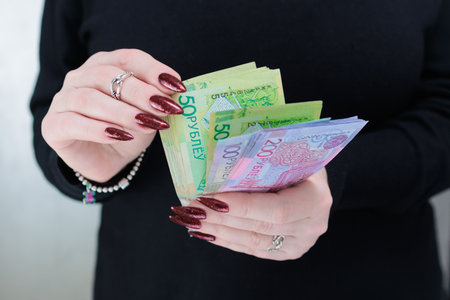 Female hands holding paper bills Belarusian rublesの写真素材