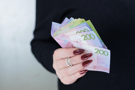 Female hands holding paper bills Belarusian rubles