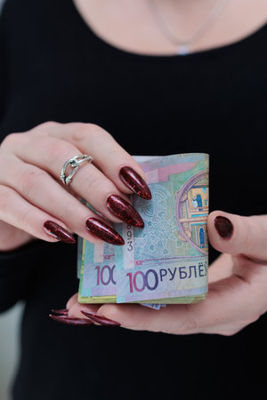 Female hands holding paper bills Belarusian rublesの写真素材