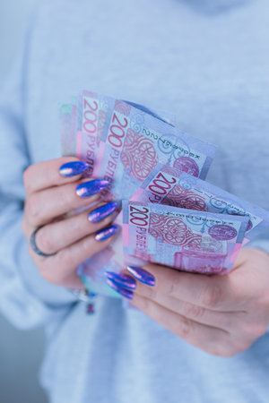 Female hands holding paper bills Belarusian rublesの写真素材