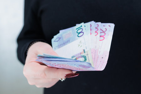 Female hands holding paper bills Belarusian rublesの写真素材