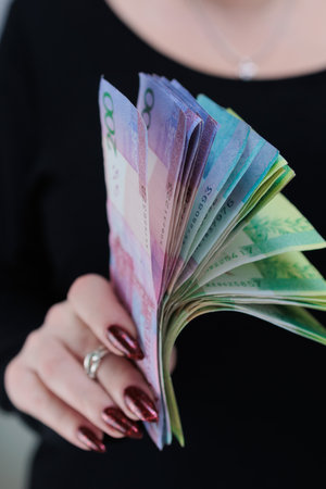 Female hands holding paper bills Belarusian rubles