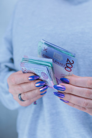 Female hands holding paper bills Belarusian rublesの写真素材
