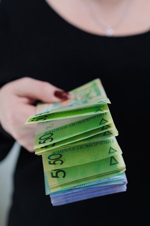 Female hands holding paper bills Belarusian rublesの写真素材