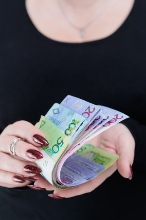 Female hands holding paper bills Belarusian rublesの写真素材