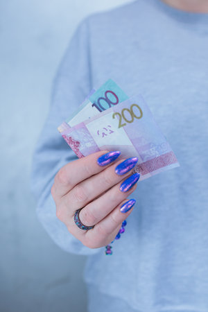 Female hands holding paper billsの写真素材