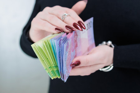Female hands holding paper bills Belarusian rublesの写真素材