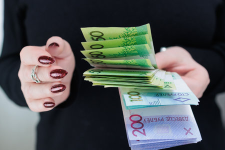 Female hands holding paper bills Belarusian rubles
