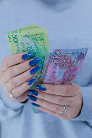 Female hands holding paper bills Belarusian rublesの写真素材