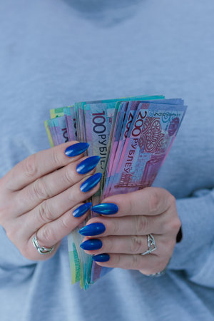 Female hands holding paper bills Belarusian rublesの写真素材