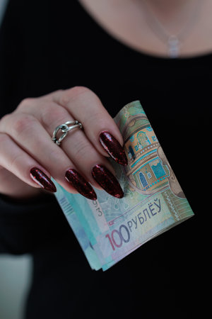 Female hands holding paper bills Belarusian rublesの写真素材