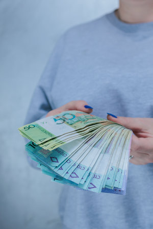 Female hands holding paper bills Belarusian rublesの写真素材