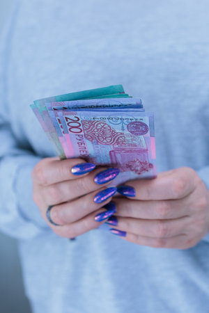 Female hands holding paper bills Belarusian rublesの写真素材
