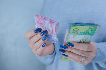 Female hands holding paper bills Belarusian rublesの写真素材