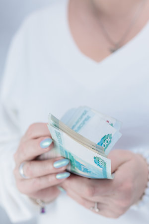 Female hands holding paper bills in Russian rublesの写真素材