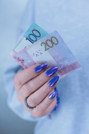 Female hands holding paper billsの写真素材