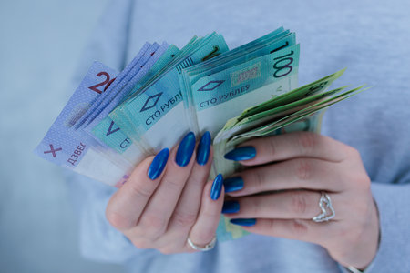 Female hands holding paper bills Belarusian rublesの写真素材