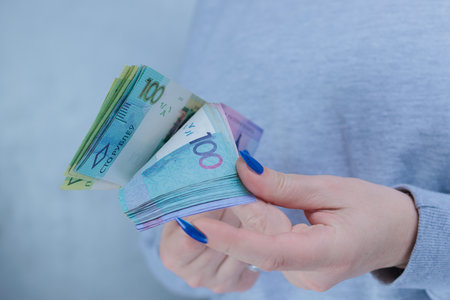 Female hands holding paper bills Belarusian rublesの写真素材