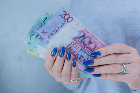 Female hands holding paper bills Belarusian rublesの写真素材