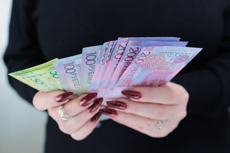 Female hands holding paper bills Belarusian rublesの写真素材
