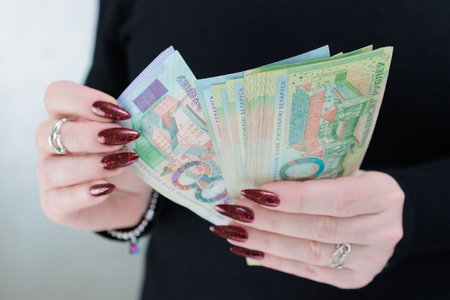 Female hands holding paper bills Belarusian rublesの写真素材
