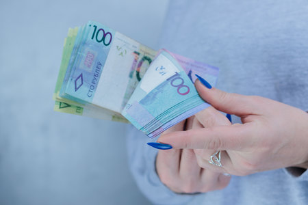 Female hands holding paper bills Belarusian rublesの写真素材