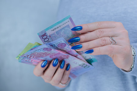 Female hands holding paper bills Belarusian rubles