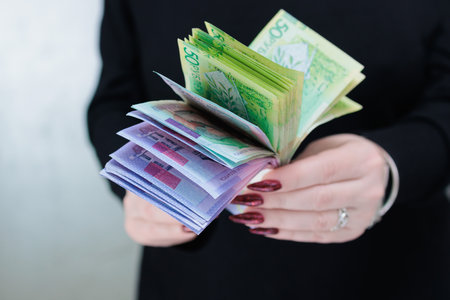 Female hands holding paper bills Belarusian rublesの写真素材