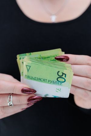 Female hands holding paper bills Belarusian rublesの写真素材