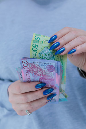 Female hands holding paper bills Belarusian rublesの写真素材