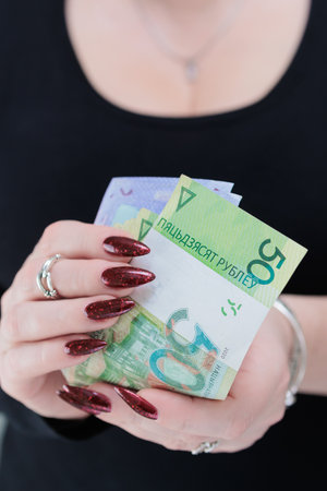 Female hands holding paper bills Belarusian rublesの写真素材
