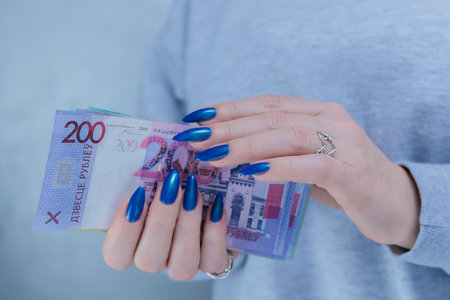 Female hands holding paper bills Belarusian rublesの写真素材