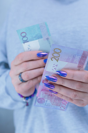 Female hands holding paper bills Belarusian rublesの写真素材