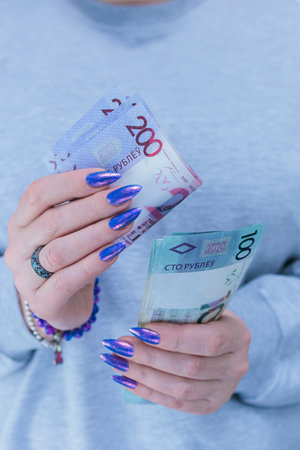 Female hands holding paper bills Belarusian rublesの写真素材