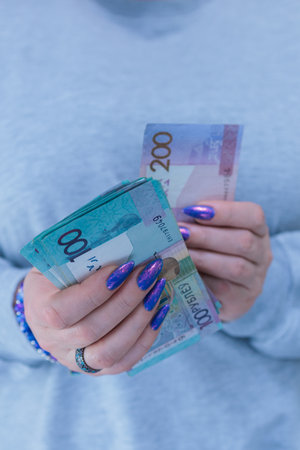 Female hands holding paper bills Belarusian rubles